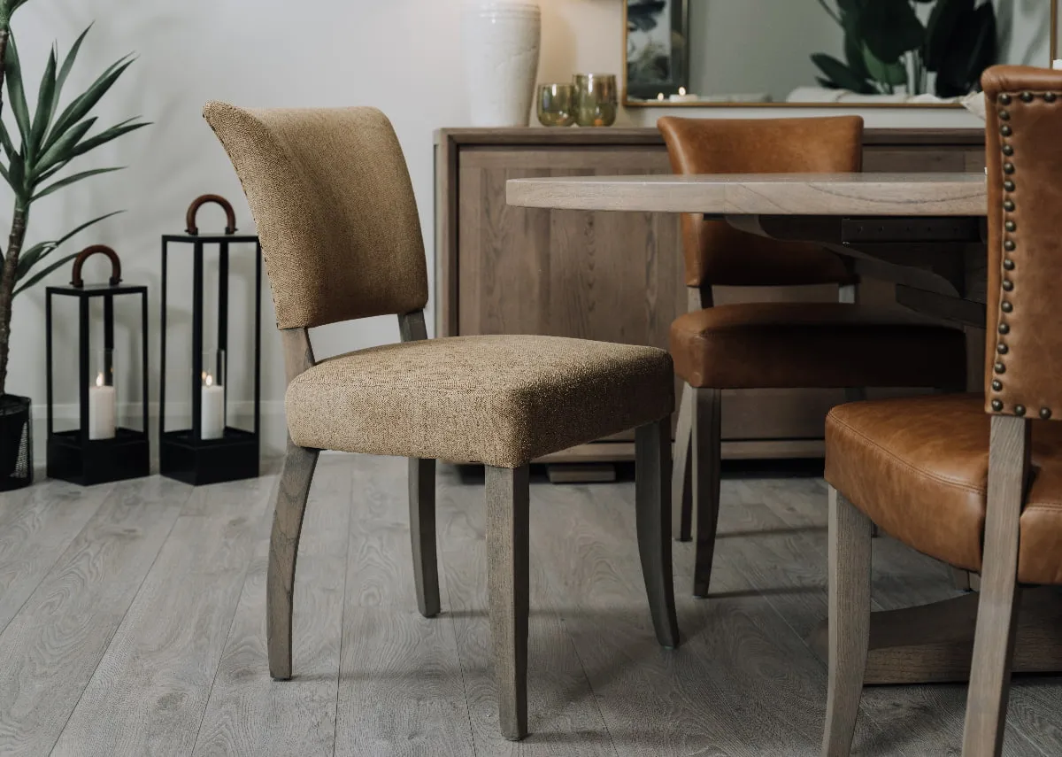 A lifestyle image of the Athy dining chair in herringbone with the Gold Coast dining table