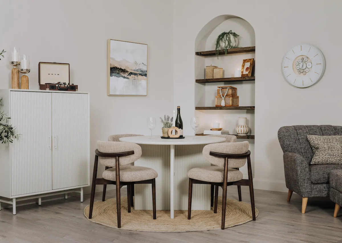 A lifestyle image of the Palma round dining table with cabinet and Hazel dining chairs