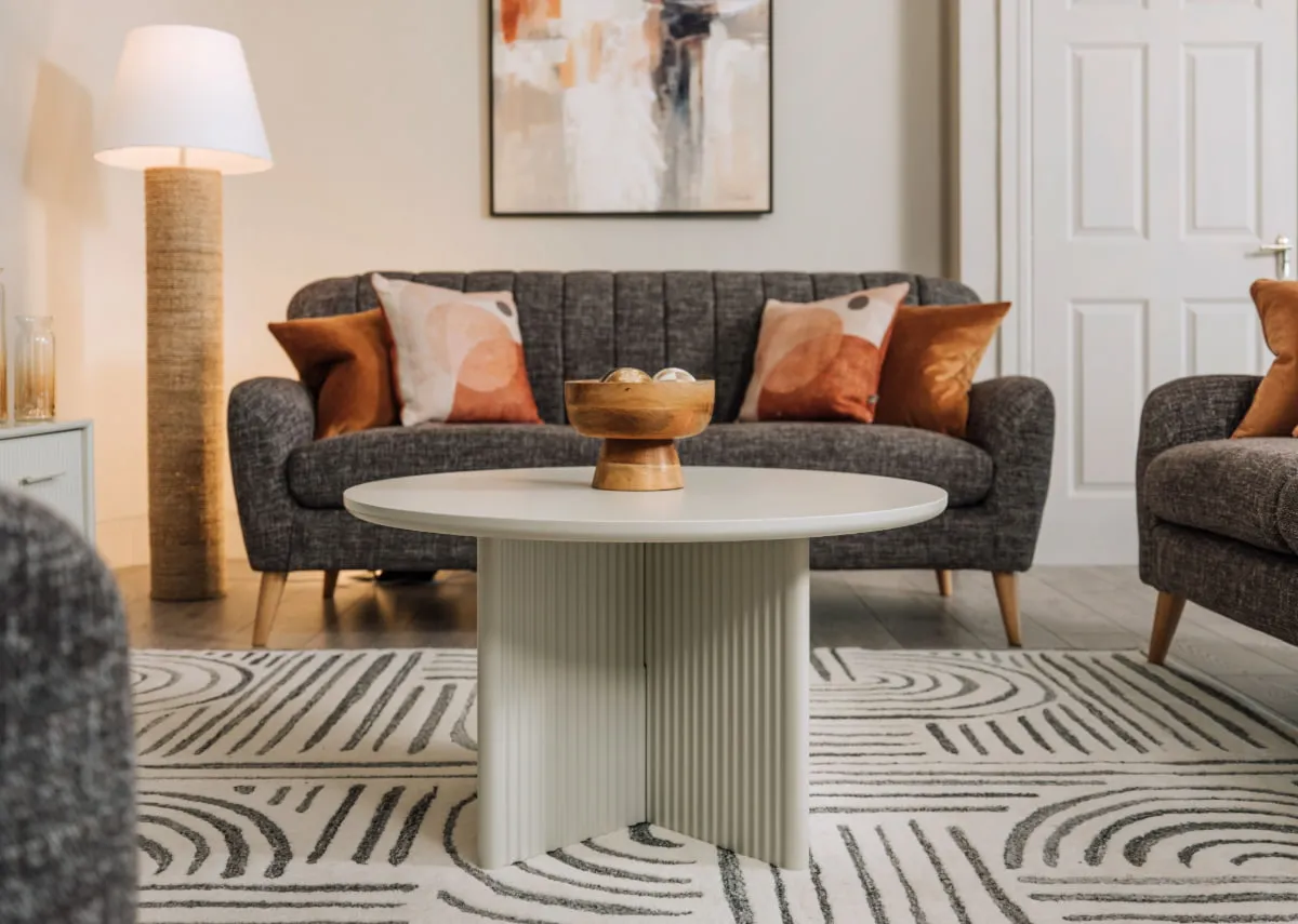 A lifestyle image of the Harper sofa range with melody floor lamp and Palma coffee table with Aurelia bowl.