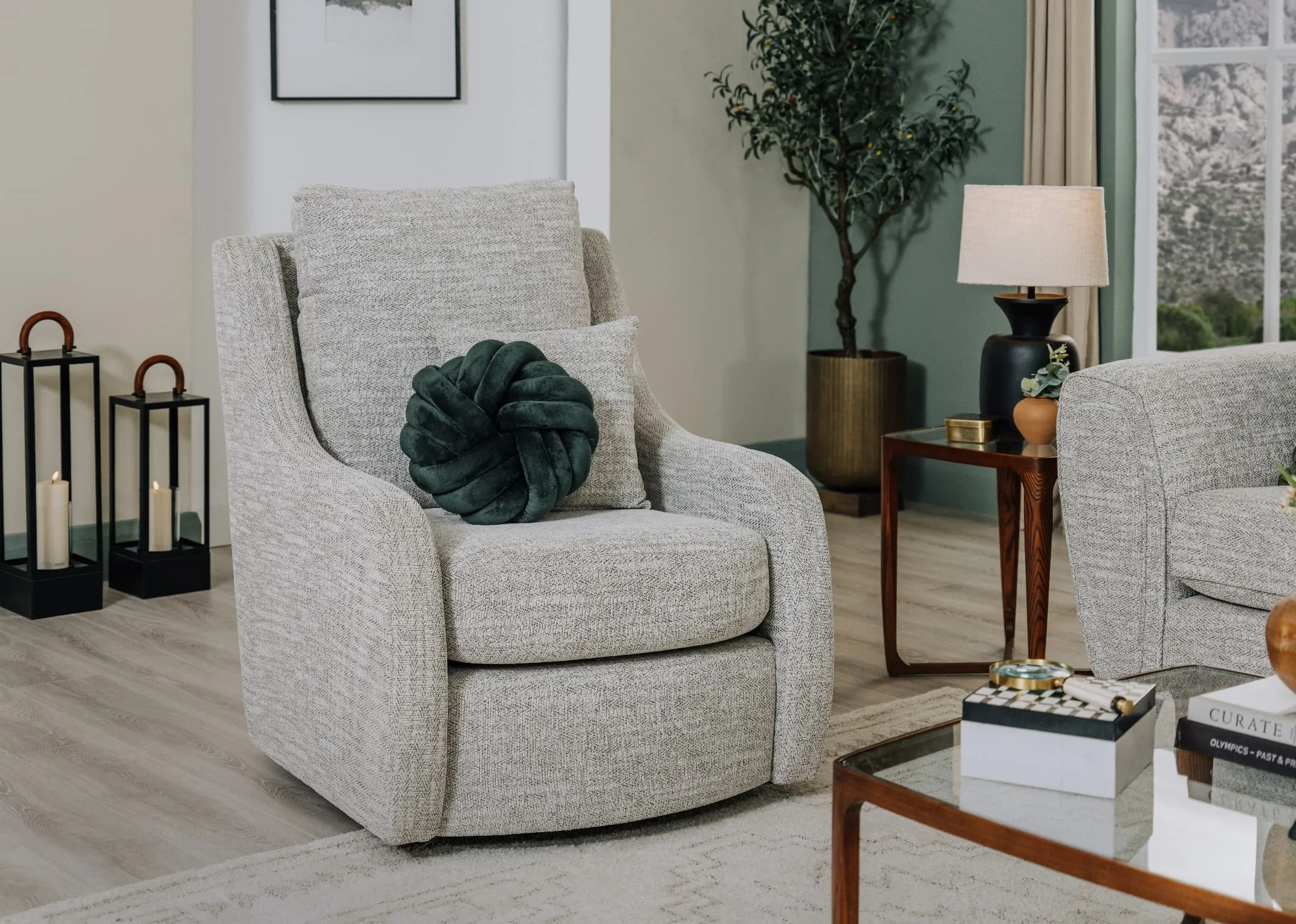 A lifestyle image of the Bella Swivel chair with Cameo coffee table.