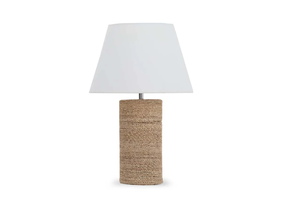 A cylindrical table lamp with woven base and white shade from EZ Livings Melody range. Front view.