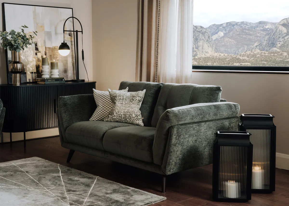A lifestyle image of the Toscana gree sofa with Ellis lanterns and Nola sideboard.