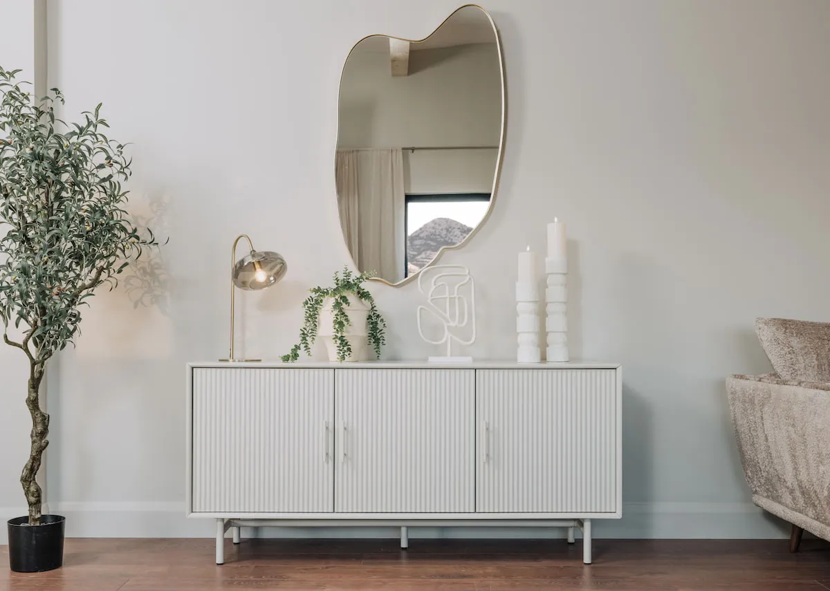 A gold table lamp with a smokey grey glass shade from EZ Livings Alisha. Closeup of inline cable switch