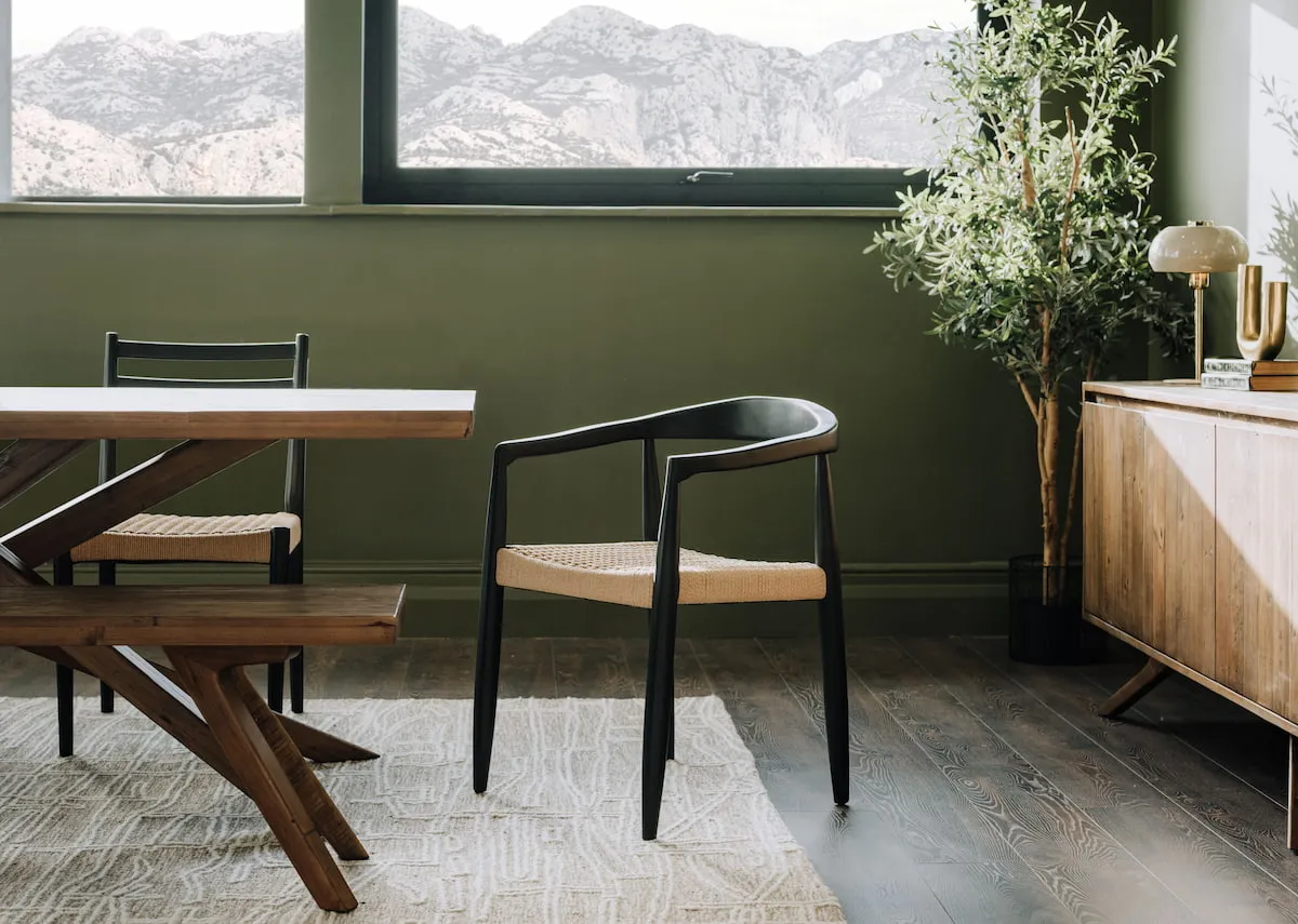 A lifestyle image of the Albion dining table with curved back dining chair & sideboard.