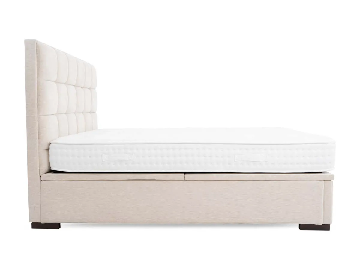 A beige ottoman bed from EZ Livings Sadie Range. View from foot of square pattern headboard