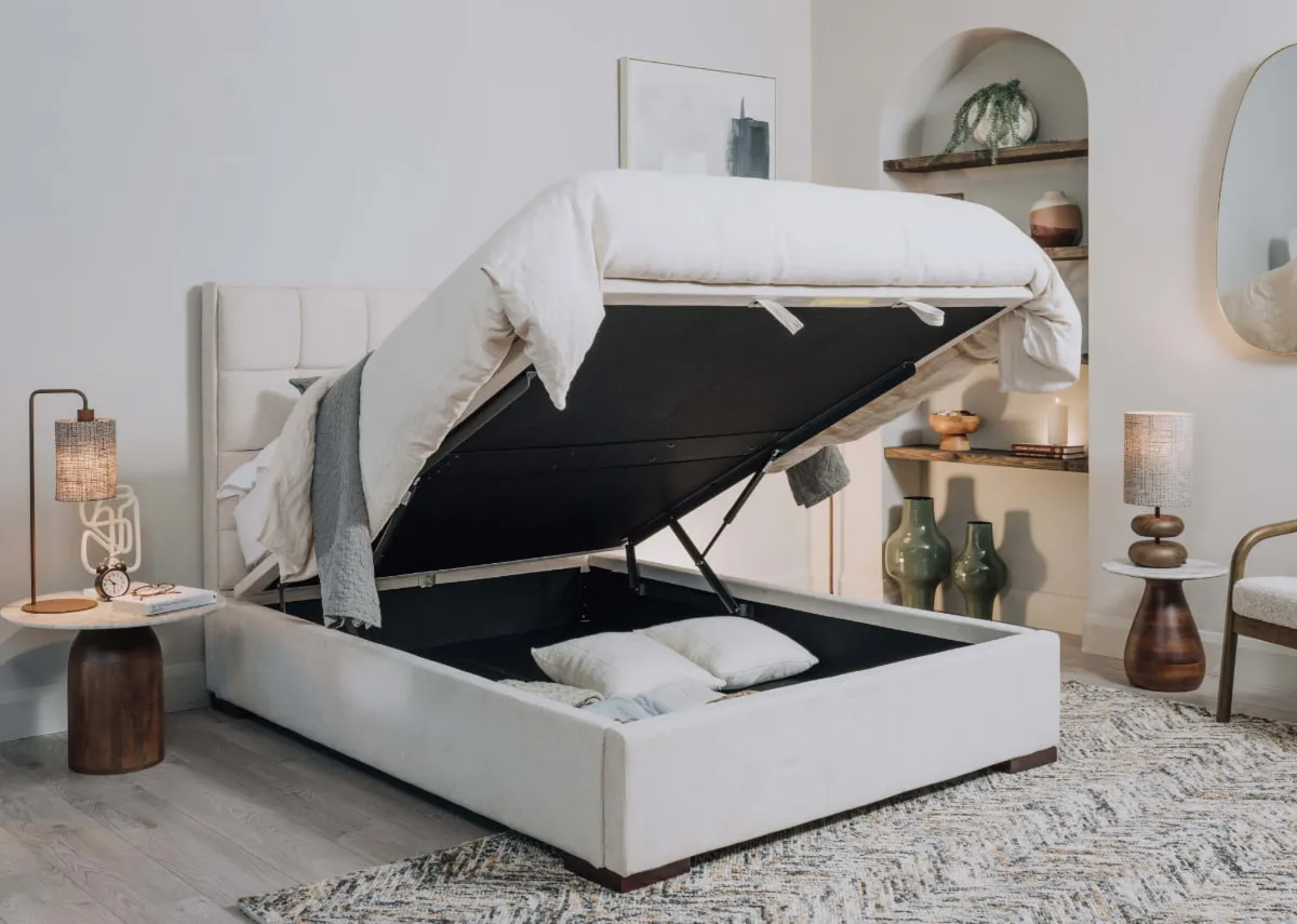 A lifestyle image of the Sadie Ottoman with slade tables and storage open showing space