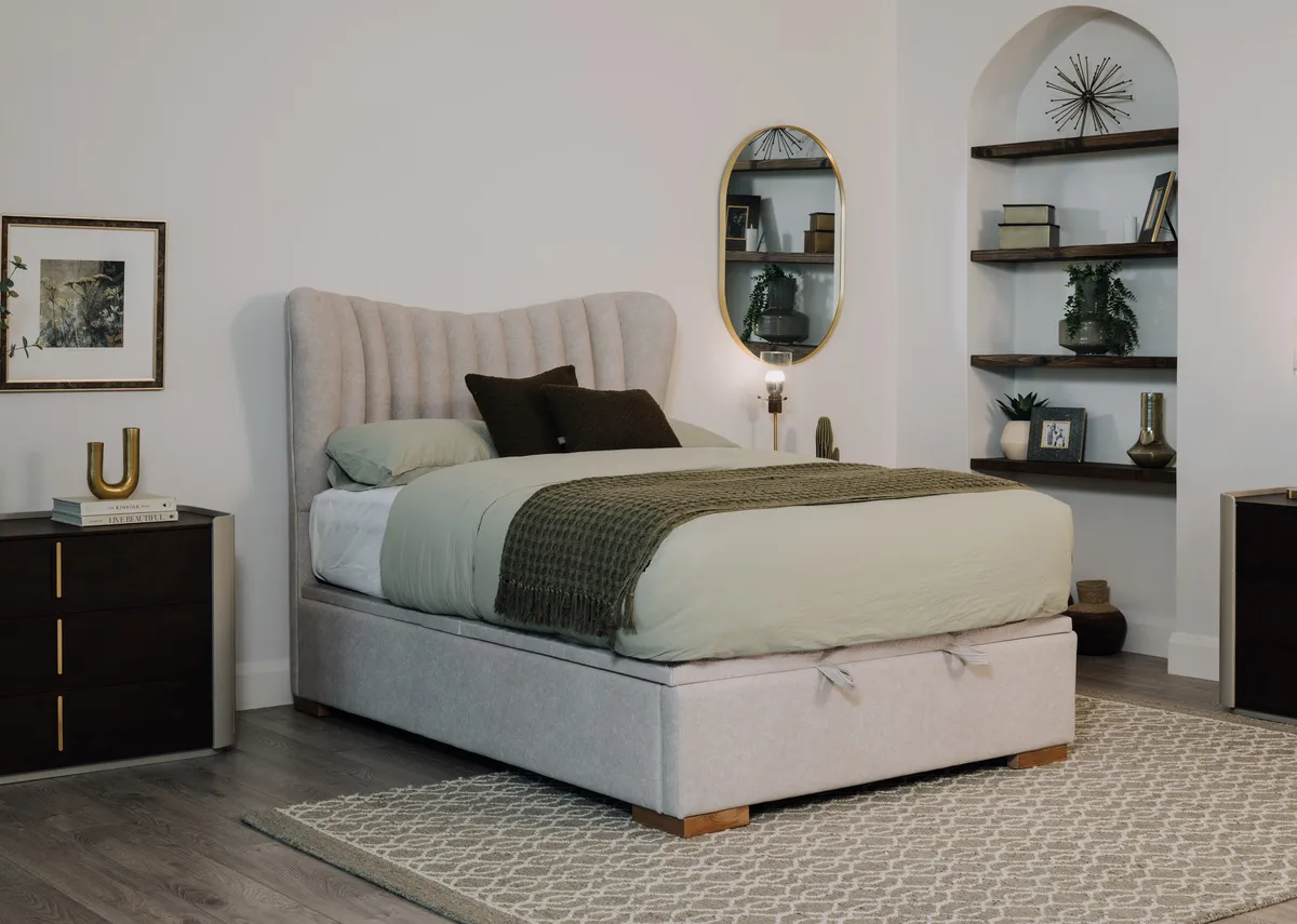 A lifestyle image of the Robin ottoman bed closed with Canna dresser and Heiny rug.