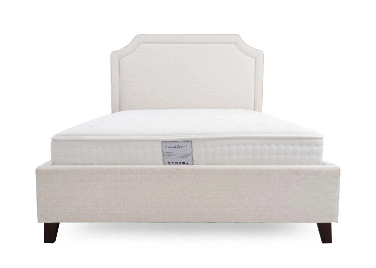 A beige fabric bed frame from EZ Livings Archie range. View of high angled cut headboard