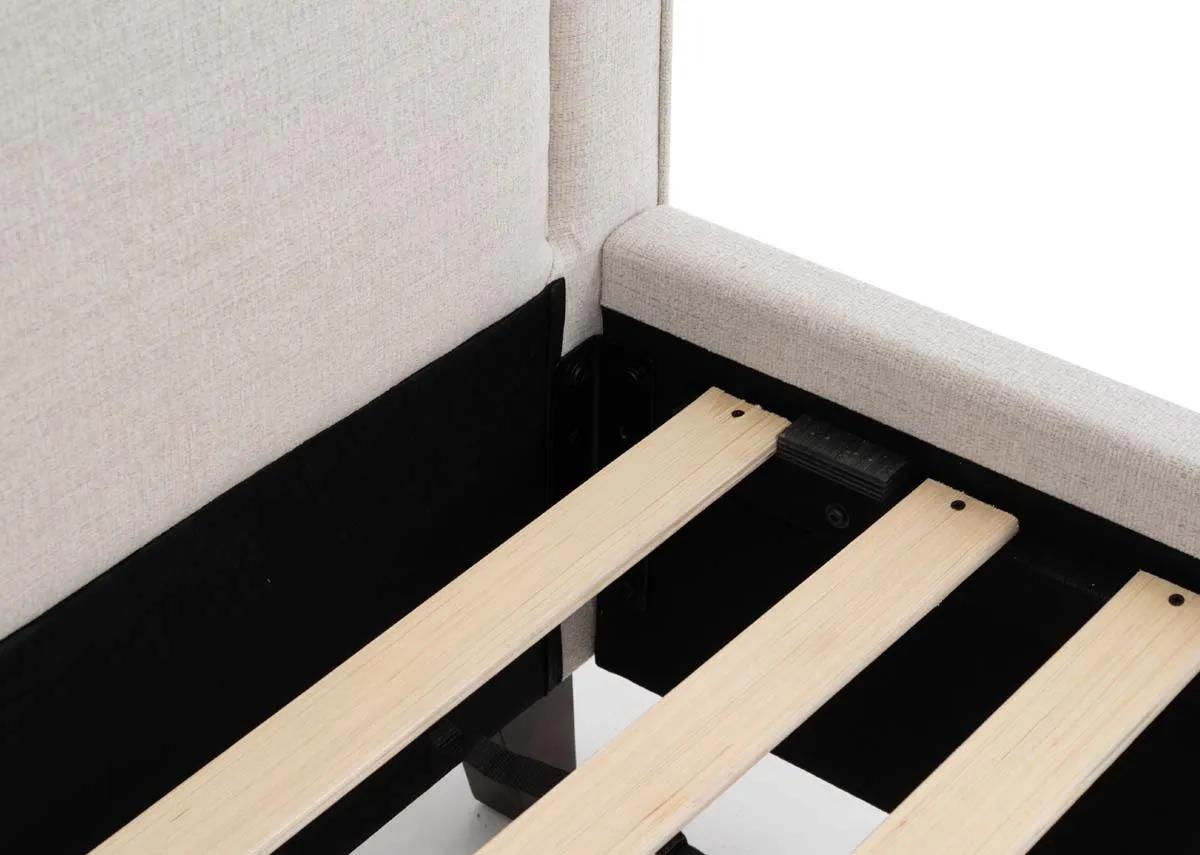 A beige fabric bed frame from EZ Livings Archie range. Closeup of slat wood base