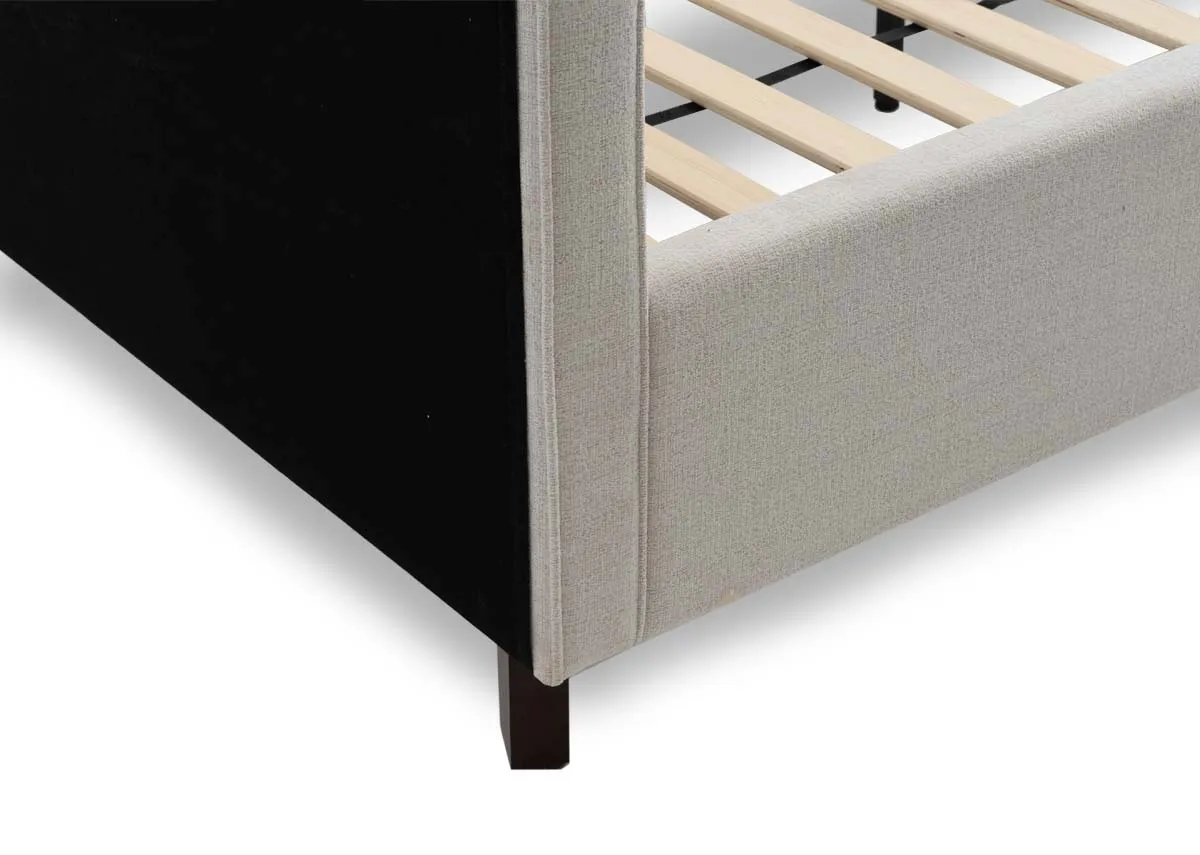 A beige fabric bed frame from EZ Livings Archie range. Closeup of walnut legs