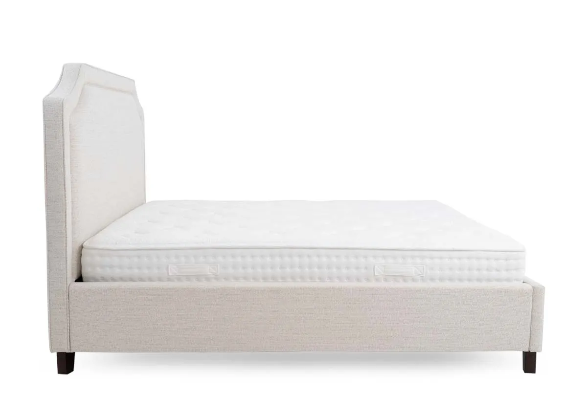 A beige fabric bed frame from EZ Livings Archie range. Side view