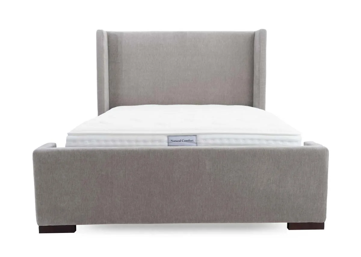 A grey fabric bed frame with high winged headboard from EZ Livings Quay west range. View from foot of high headbaord