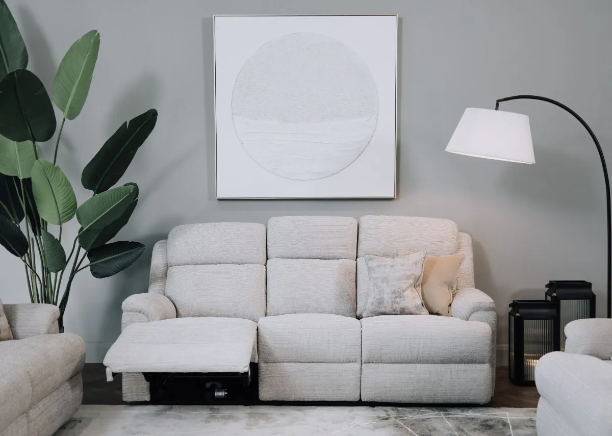 A lifestyle image of the Embrace silver 3 seater reclined with arc lamp and pathways canvas.