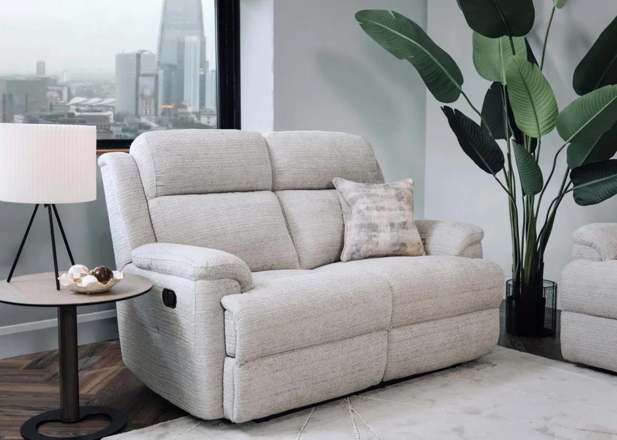 A lifestyle image of the Embrace silver 2 seater with starlette lamp on blanco side table.