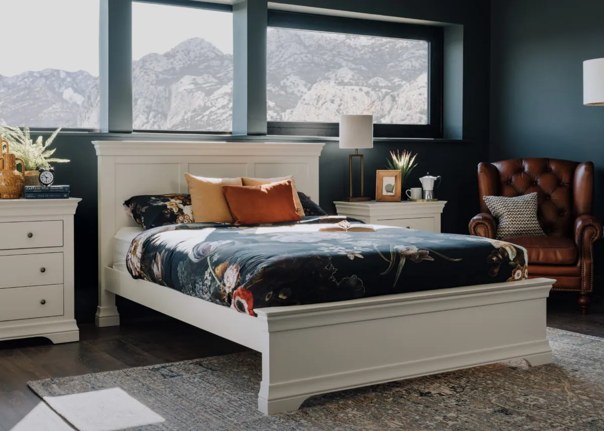 A lifestyle image of the Dove bed with chest and locker with Maxima rug.