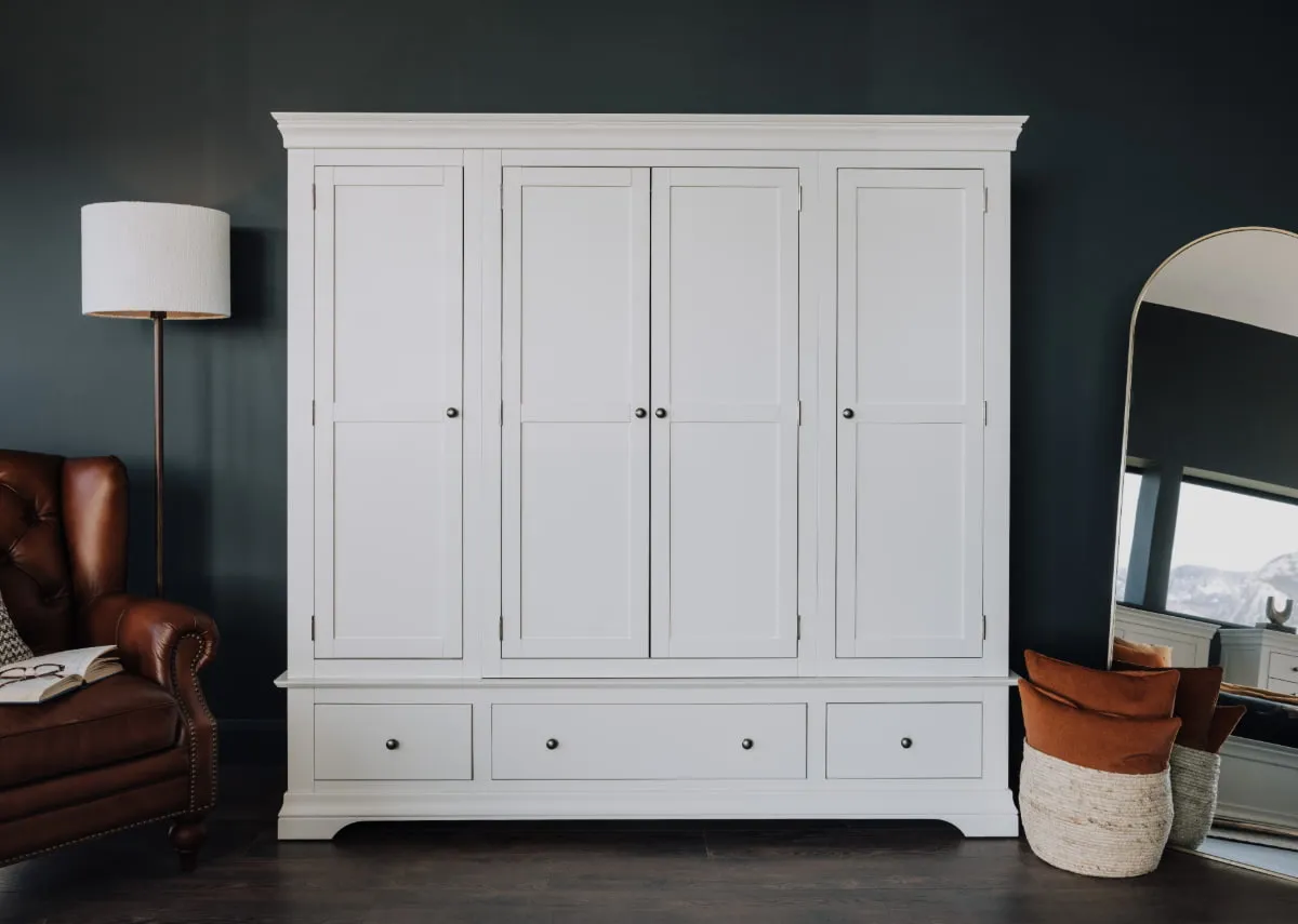 A lifestyle image of the Dove wardrobe with Adare armchair