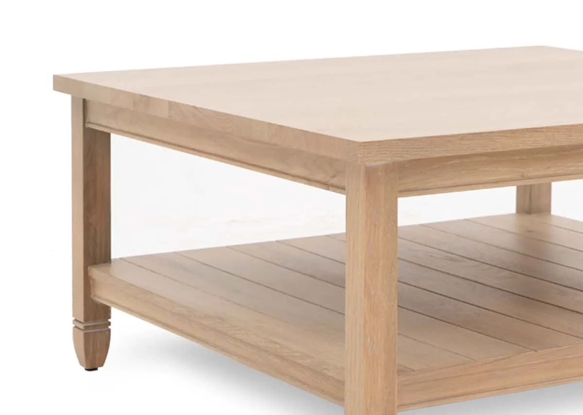 A square oak coffee table with chunky top and lower shelf from EZ Livings Dawn range. Closeup of oak veneer finish.
