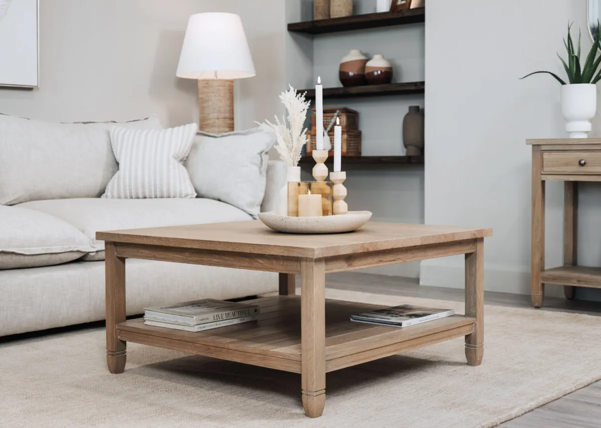 A lifestyle image of the Dawn table with a selection of light & living accessories displayed in a dish on top.