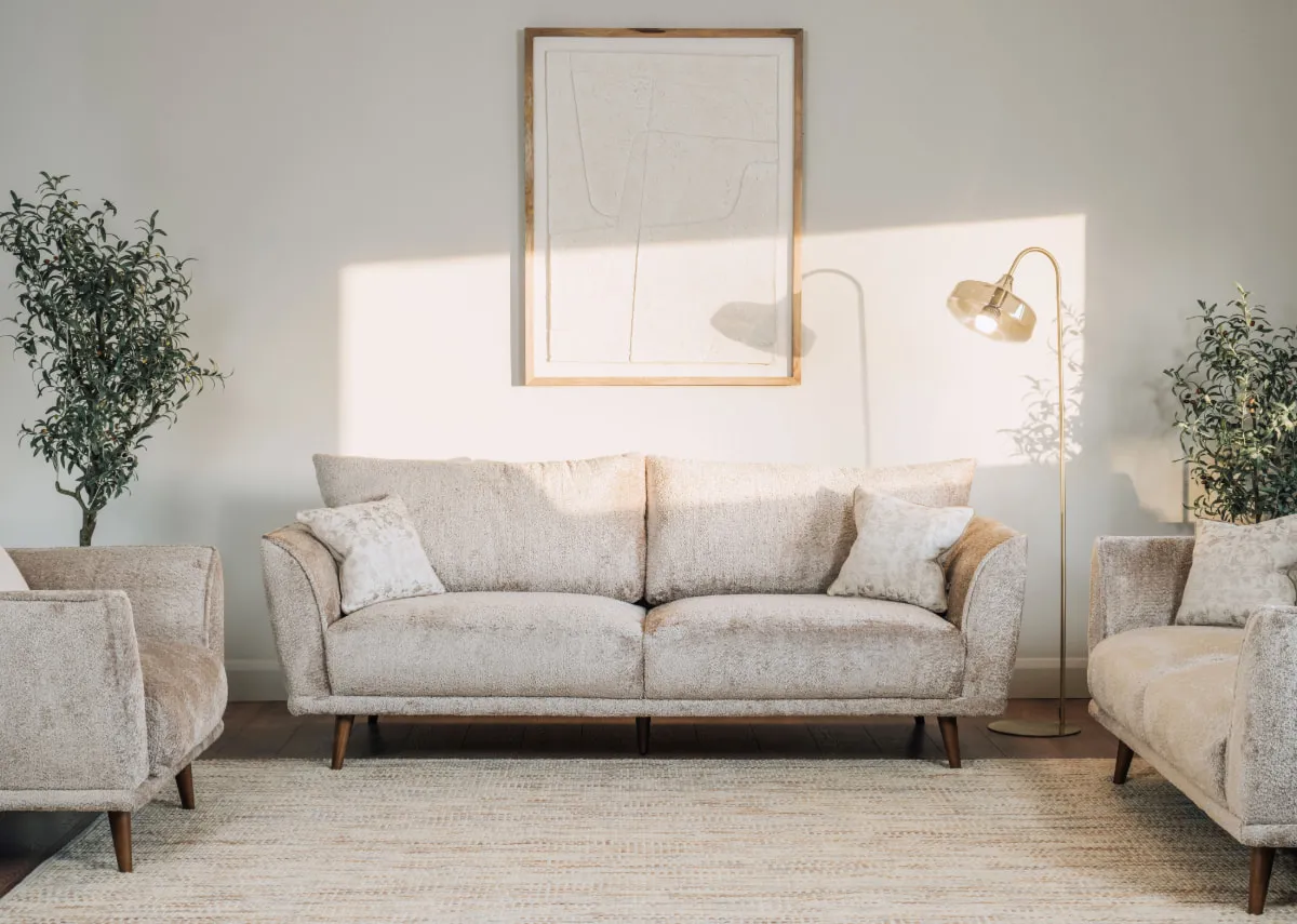 A lifestyle image of the Boutique 4 seater and 2 seater with armchair and Alisha lamp