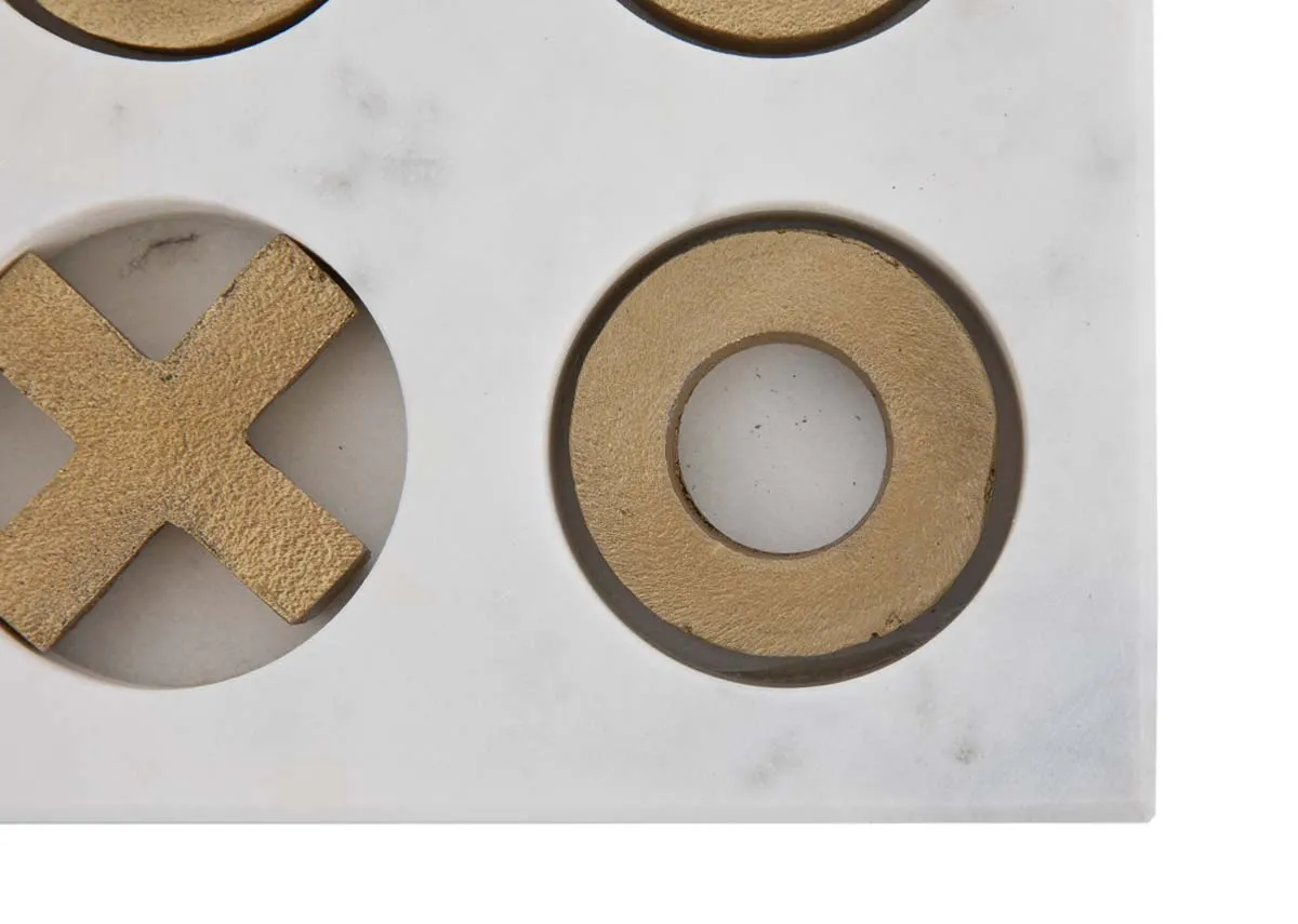 A white marble tik tac toe ornament with gold inserts from EZ Livings Home Decor range.Closeup of gold x and o