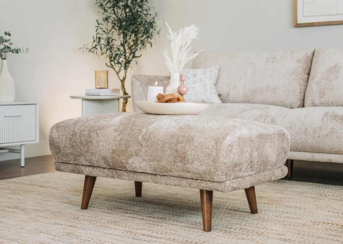 A lifestyle image of the Boutique large footstol with a white dish on top with LED candle