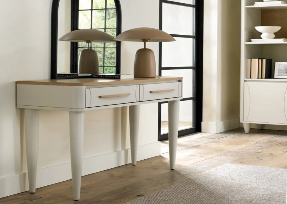 A lifestyle image of the Larsen console table with a lamp and mirror.