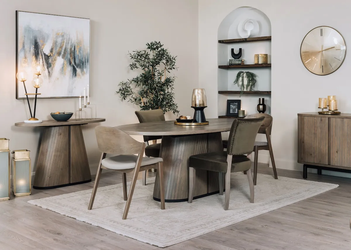 A lifestyle image of the Vega dining table with matching chairs and sideboard/console