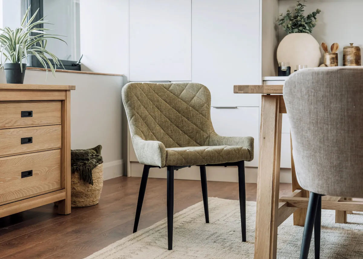 A lifestyle image of the Ottowa green chair with Albany dining table