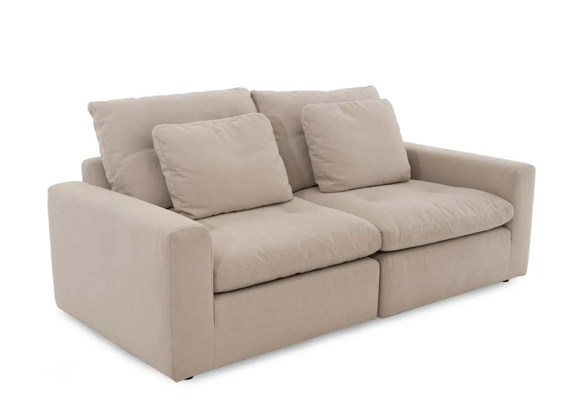 A 2 seater light grey sofa from EZ Livings Cozy range. Angled view of the compact sofa with 2 scatters