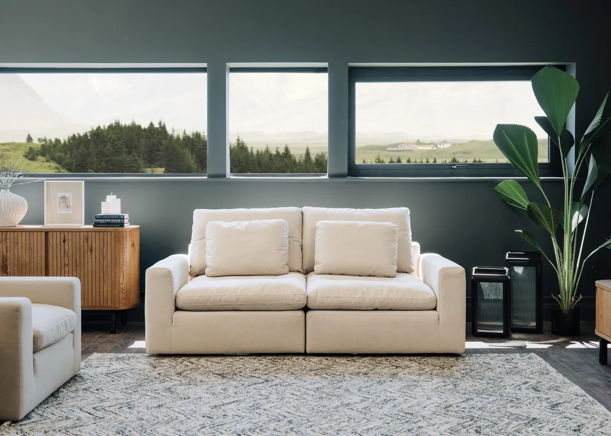 A 2 seater Cozy beige fabric sofa with the Vega sideboard and Cozy armchair