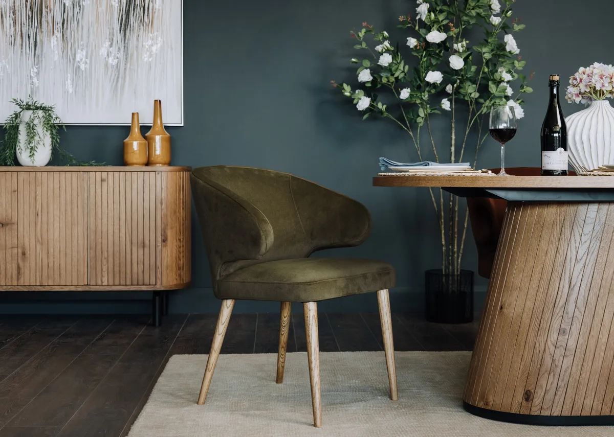 A lifestyle image of the Victor dining chair with dining table and sideboard