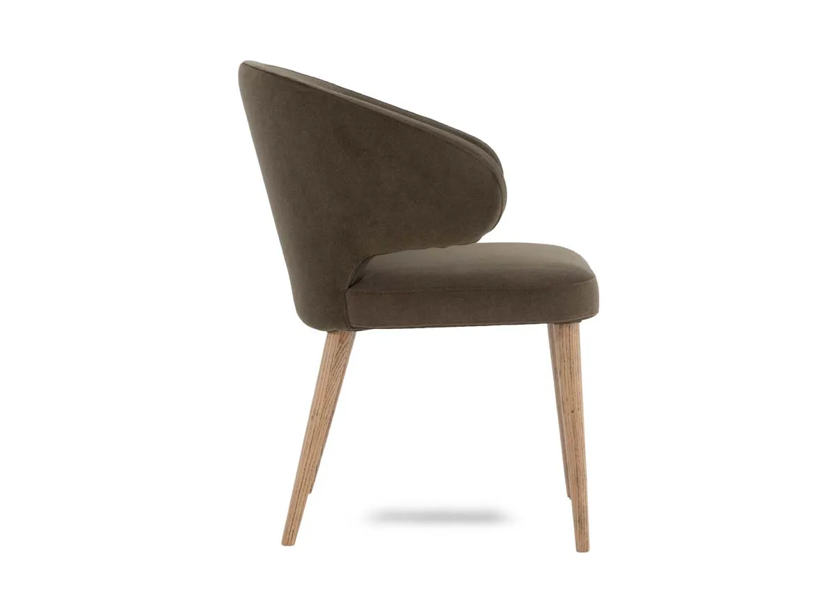 A green fabric dining chair from EZ Livings Victor range. Side view of foam seat