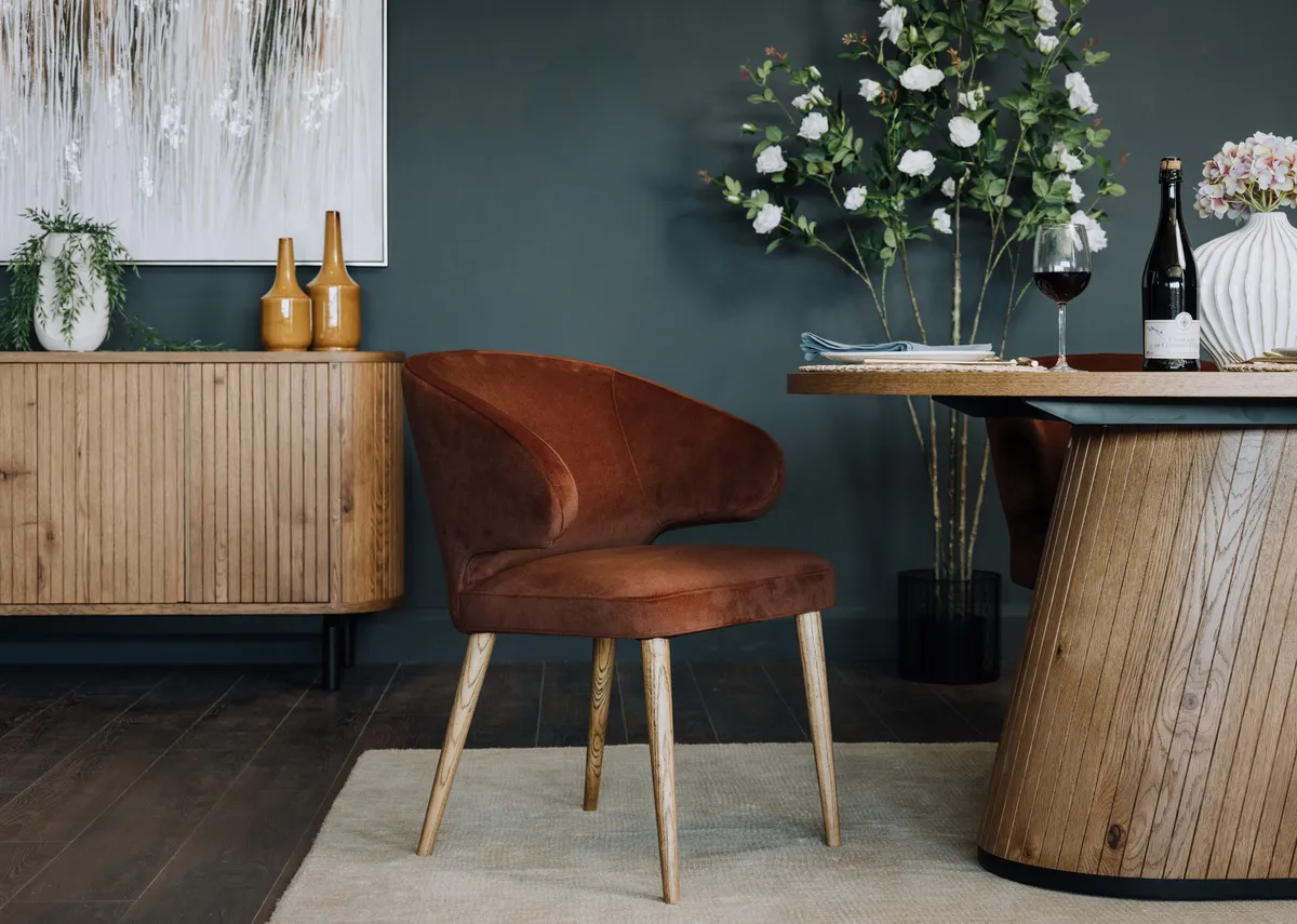 A lifestyle image of the Victor chair with Vega table and sideboard.