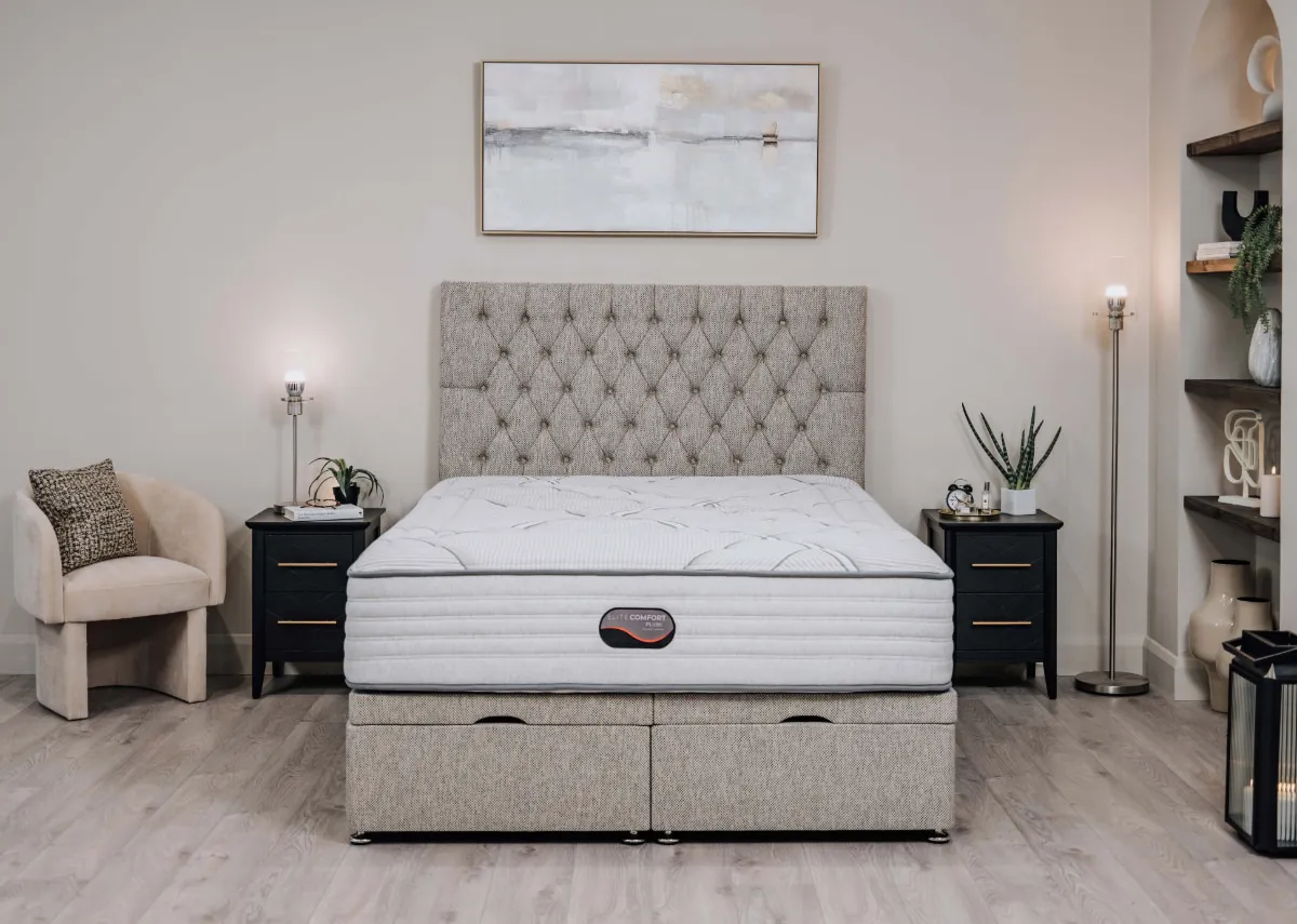 A lifestyle image of the Elite Comfort plush mattress on a plaermo bed base with chevron locker and hope chair.