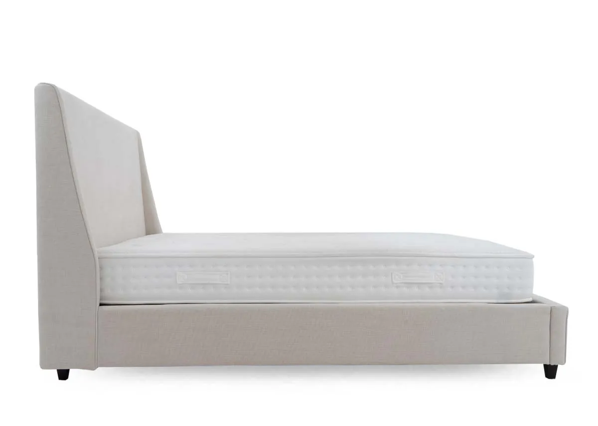 A beige fabric bed frame from EZ Livings Saoirse range. Side view