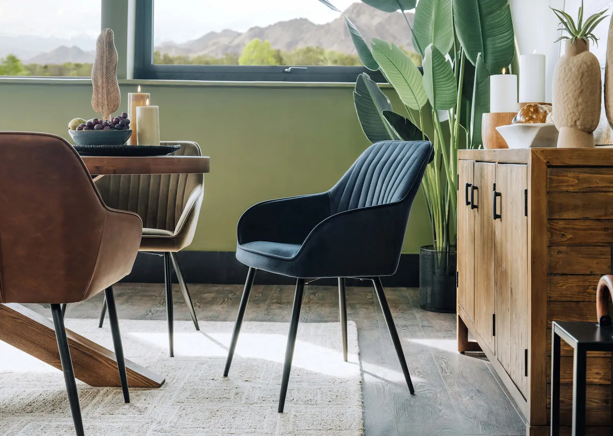 A lifestyle image of the Nolan chair in blue with the Oslo dining table