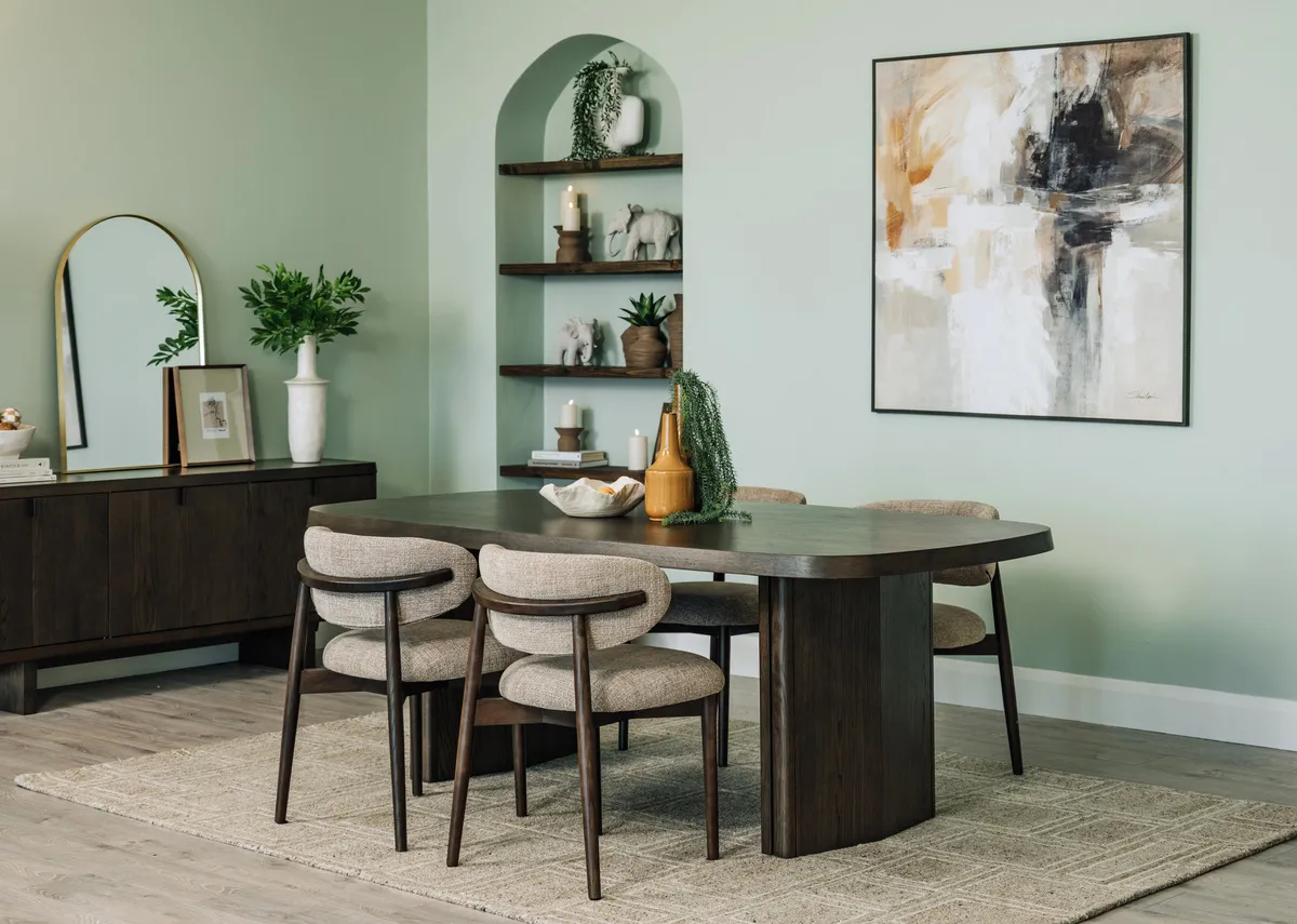 A lifestyle image of the Rimini dining table and wishbone chairs with Memphis rug