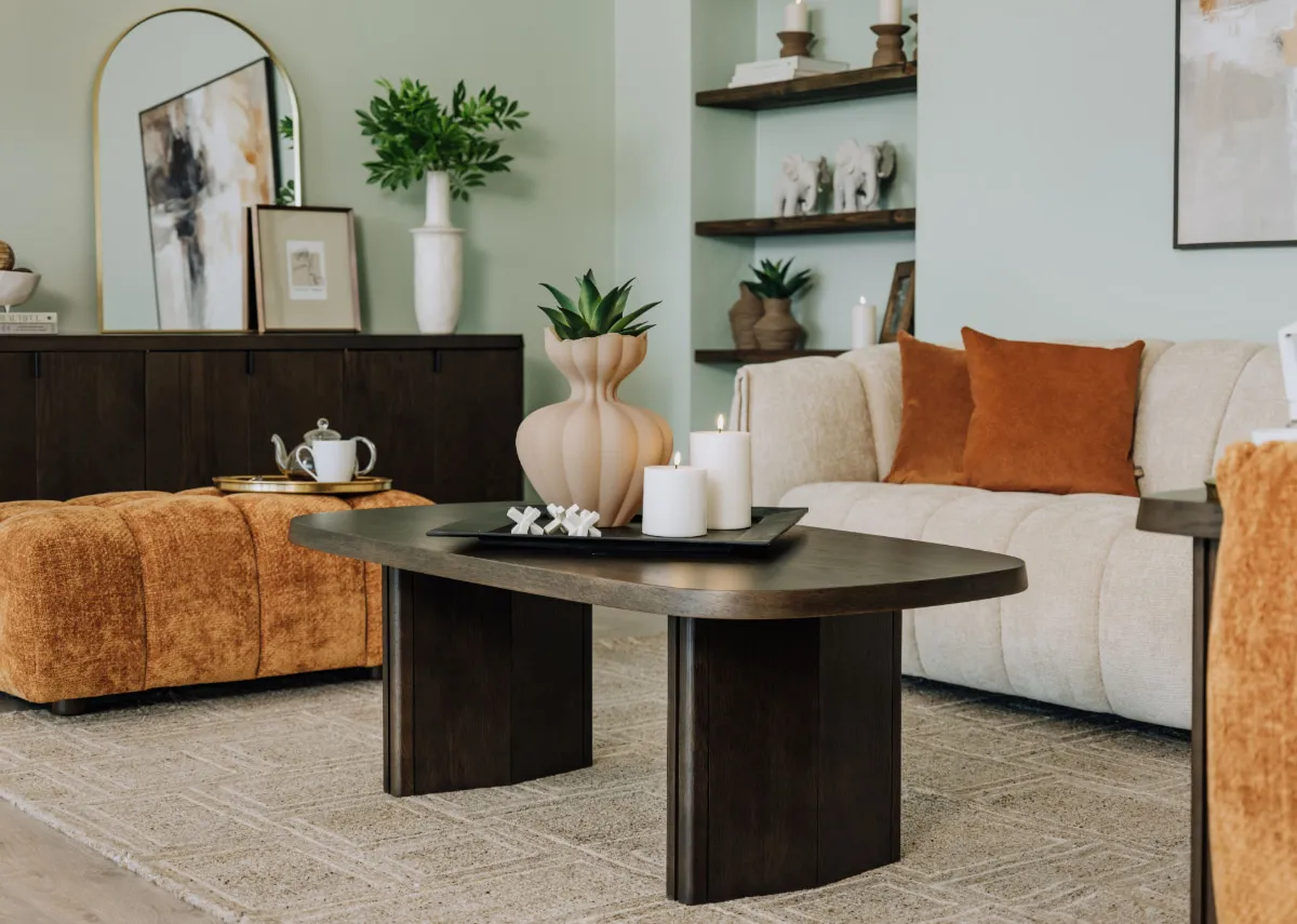 A lifestyle image of the Natu coffee table with Matera rust & ivory sofas.