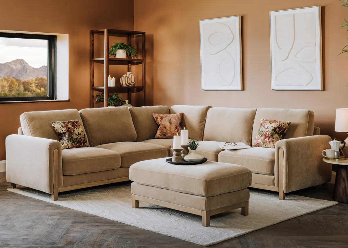 A lifestyle image of the Miller corner sofa with matching footstool with Gateway prints and Kira tables