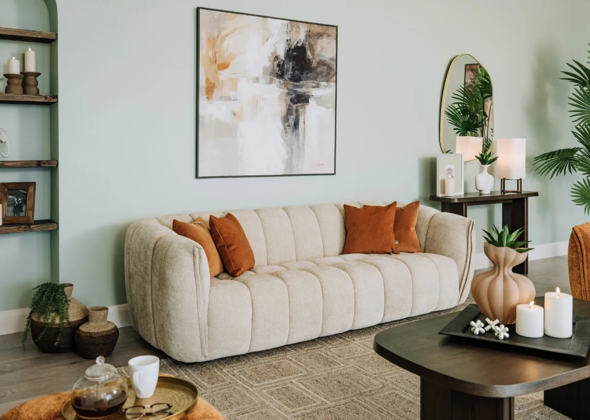A lifestyle image of the Matera 4 seater with rust velvet cushions and Evocative print.
