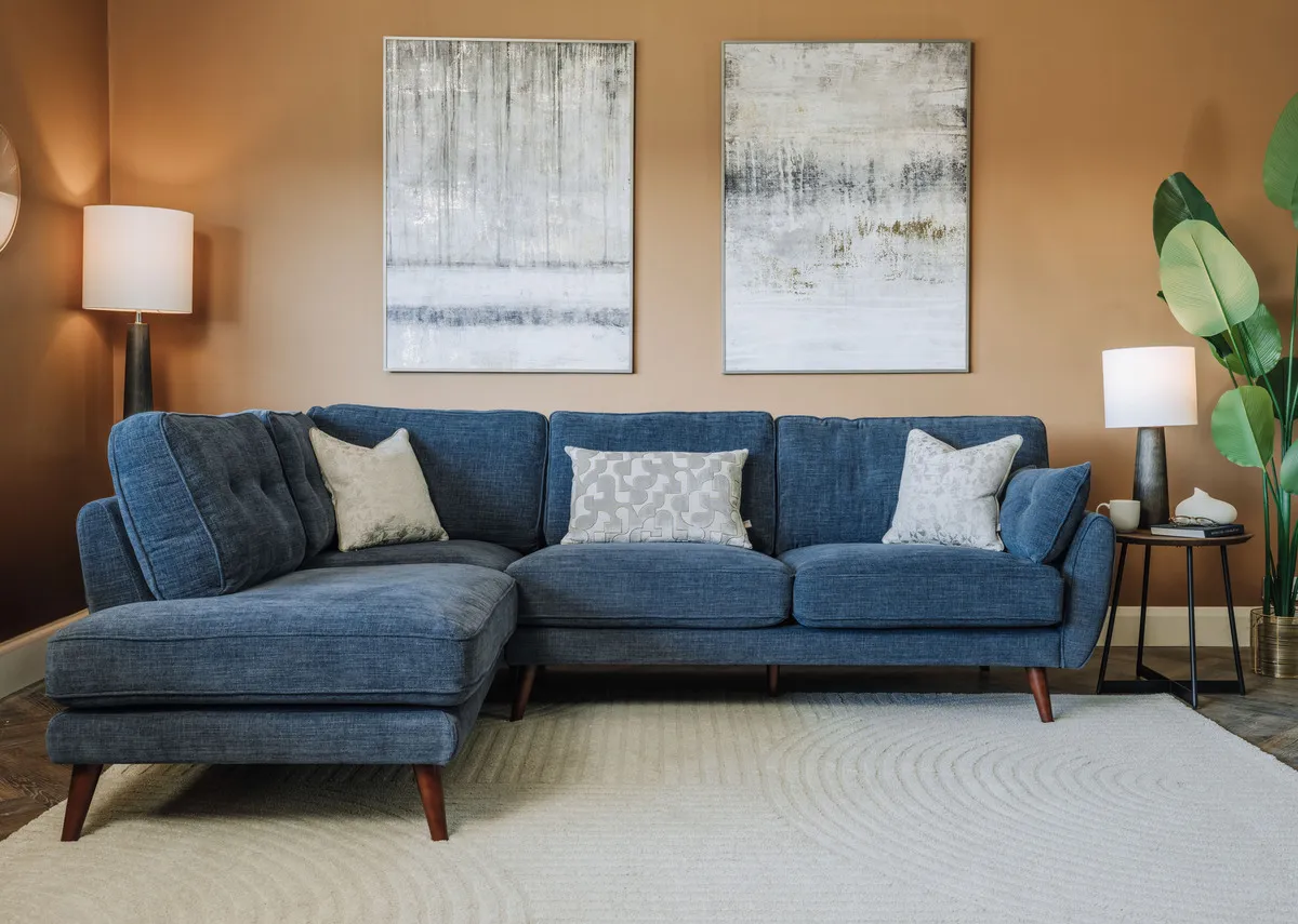 A lifestyle image of the Caoimhe RHF Corner chaise with Torrent prints and tate lamps.