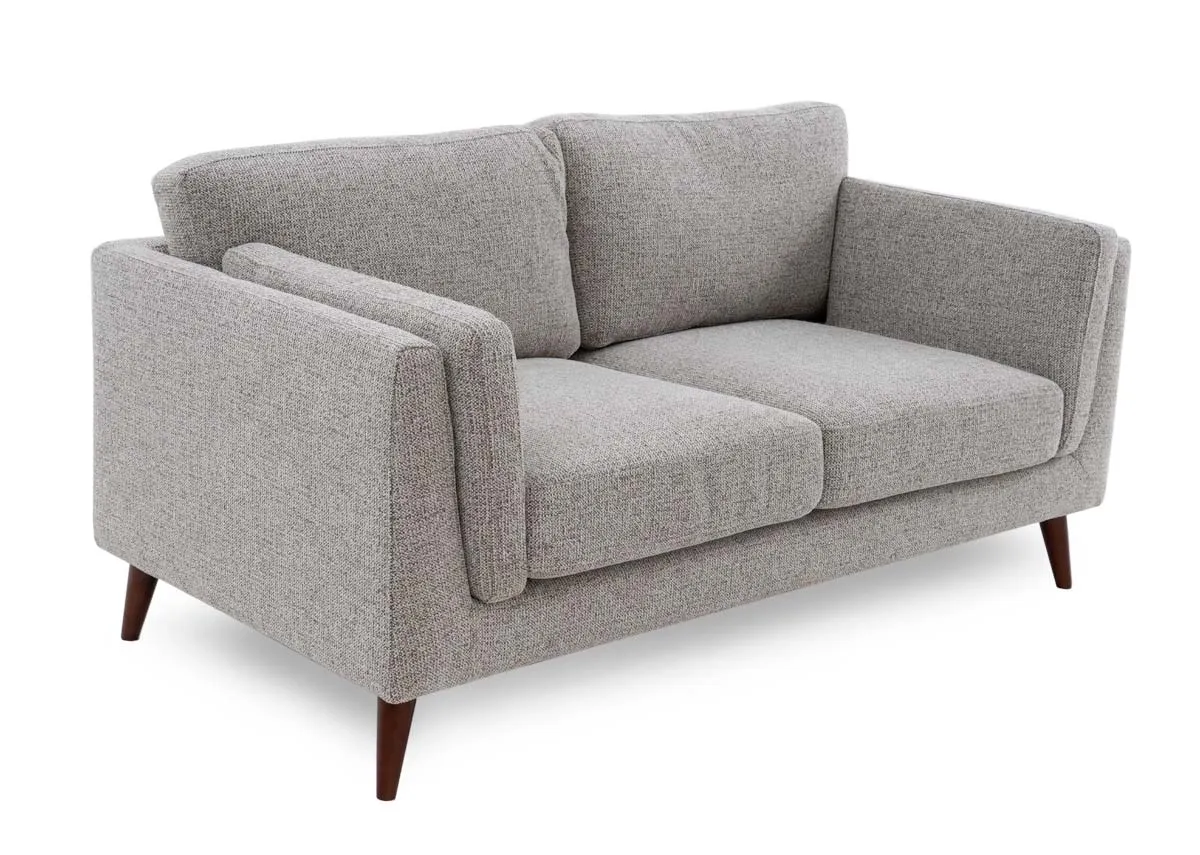 A light brown accent 2 seater sofa from EZ Livings Bailey range. Angled view of retro style sofa.
