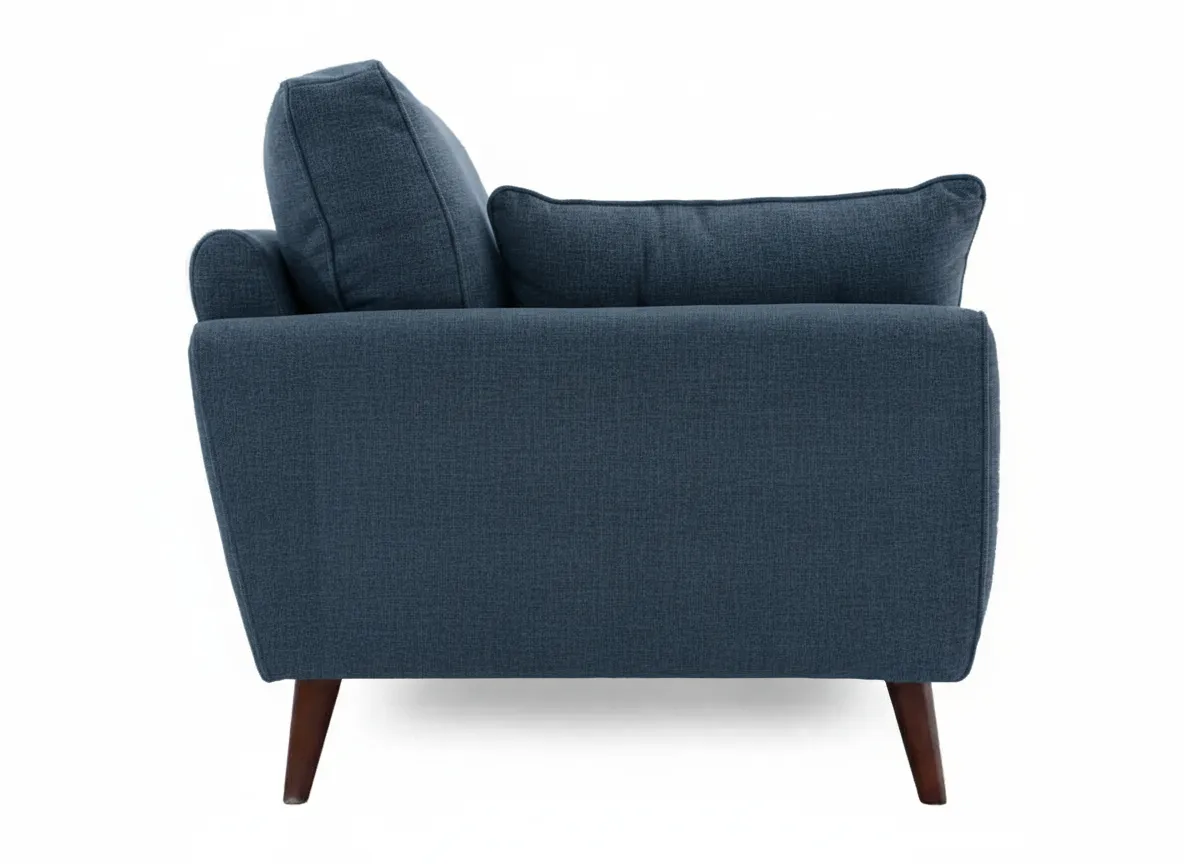 A blue fabric armchair viewed from the right side showcasing its padded armrest and exposed tapered wooden legs.