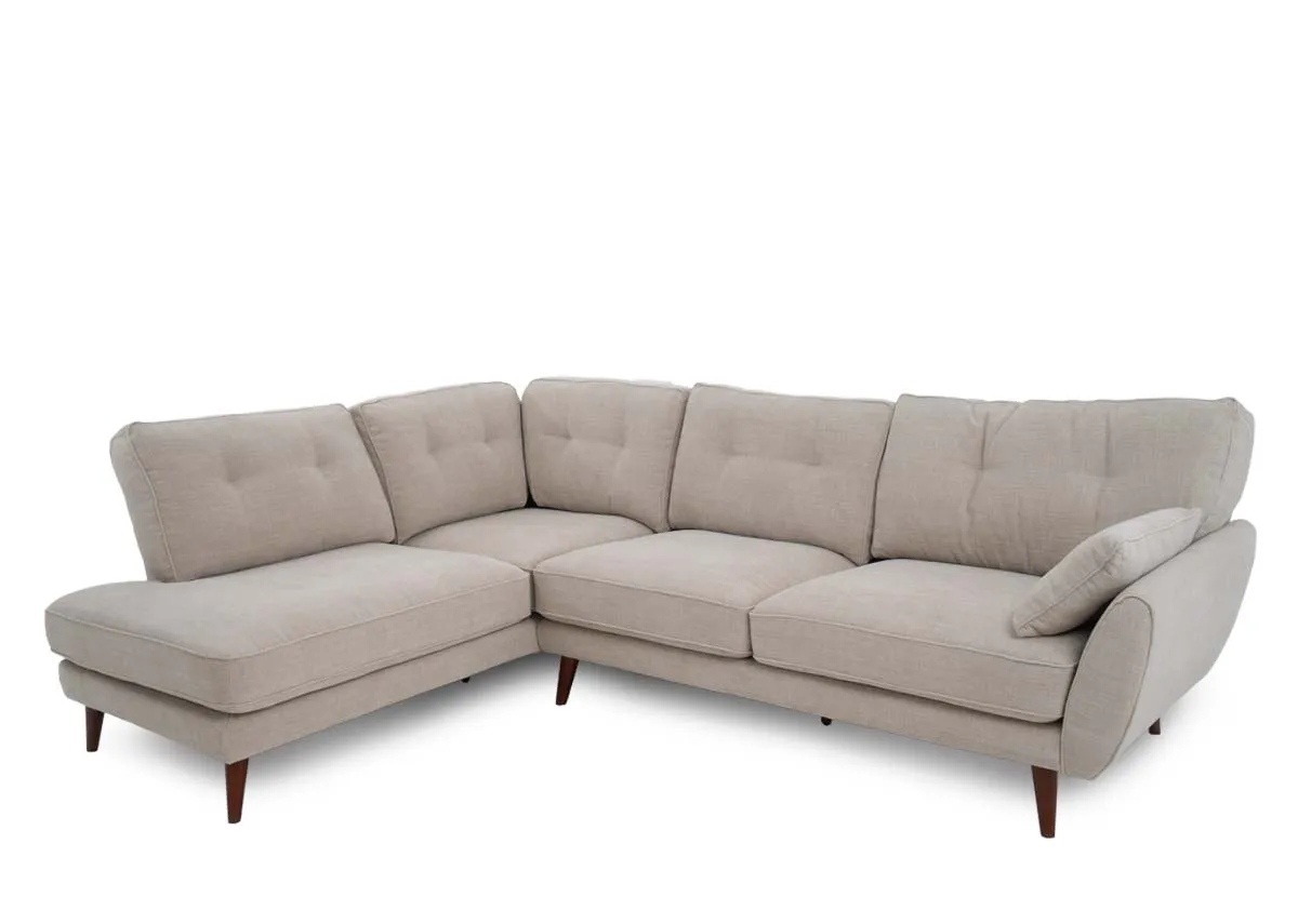 A natural fabric corner sofa from EZ Livings Caoimhe range. Angled view.