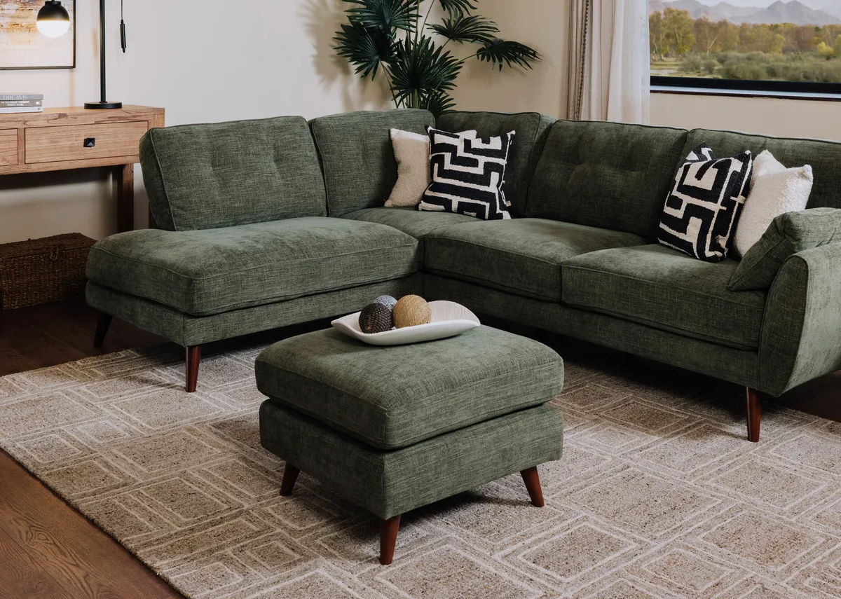 A lifetsyle image of the Caoimhe green corner chaise with free footstool.