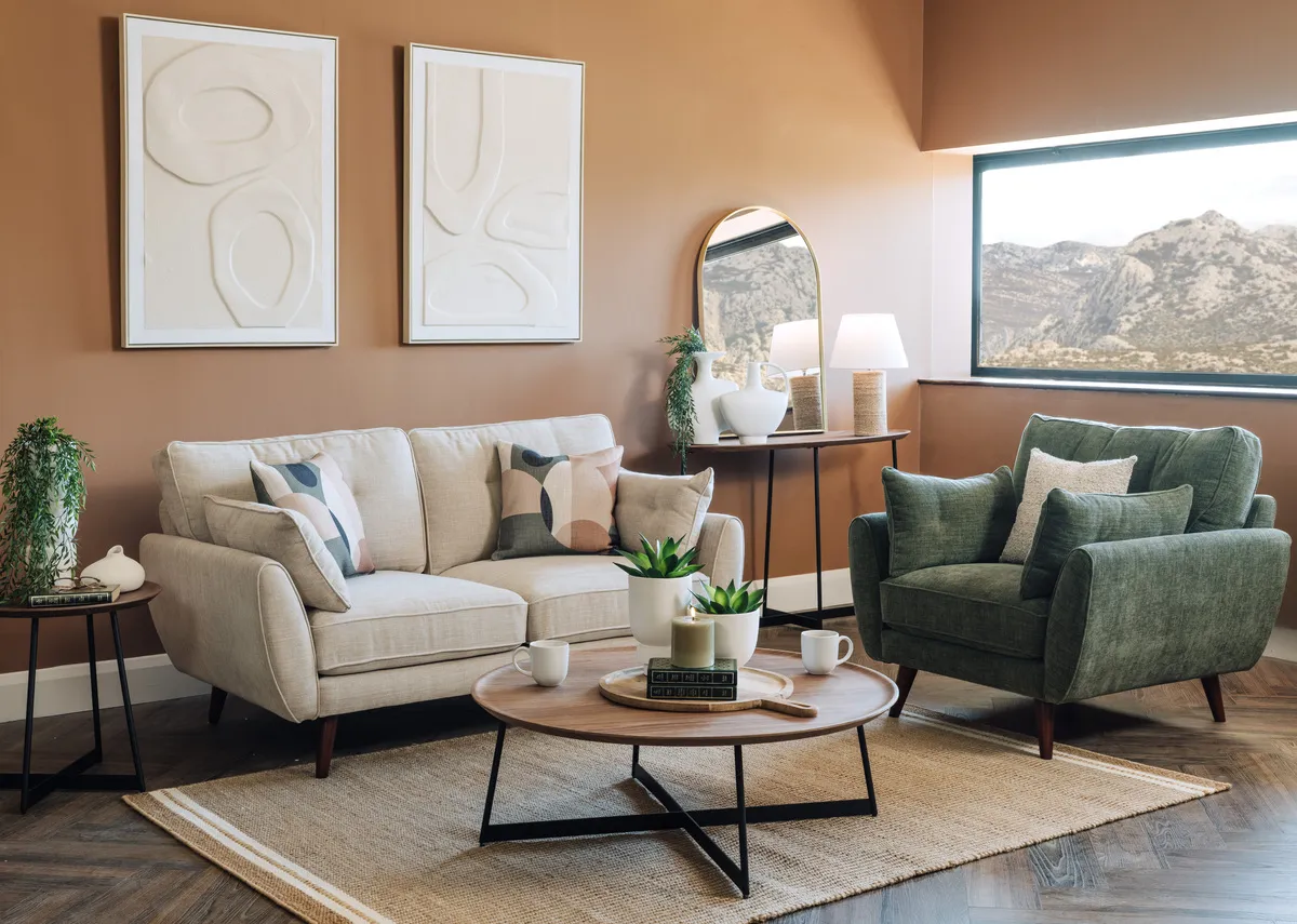 A lifestyle image of the Caoimhe natural 3 seater with olive armchair with Natu tables and canvas prints