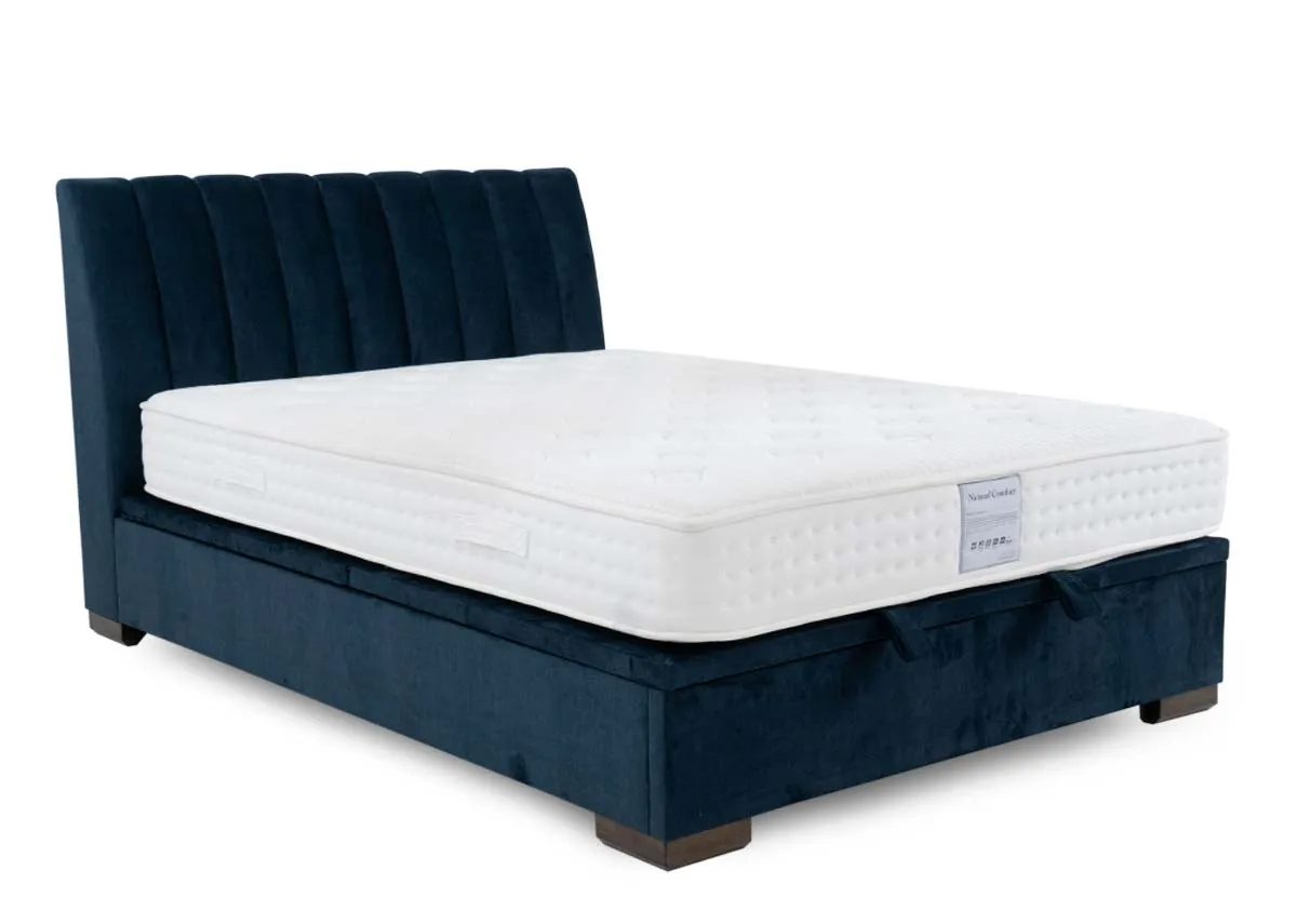 A 5ft ottoman bed in petrol blue from EZ Livings Lancelot range. Angled view of bed with mattress not included.