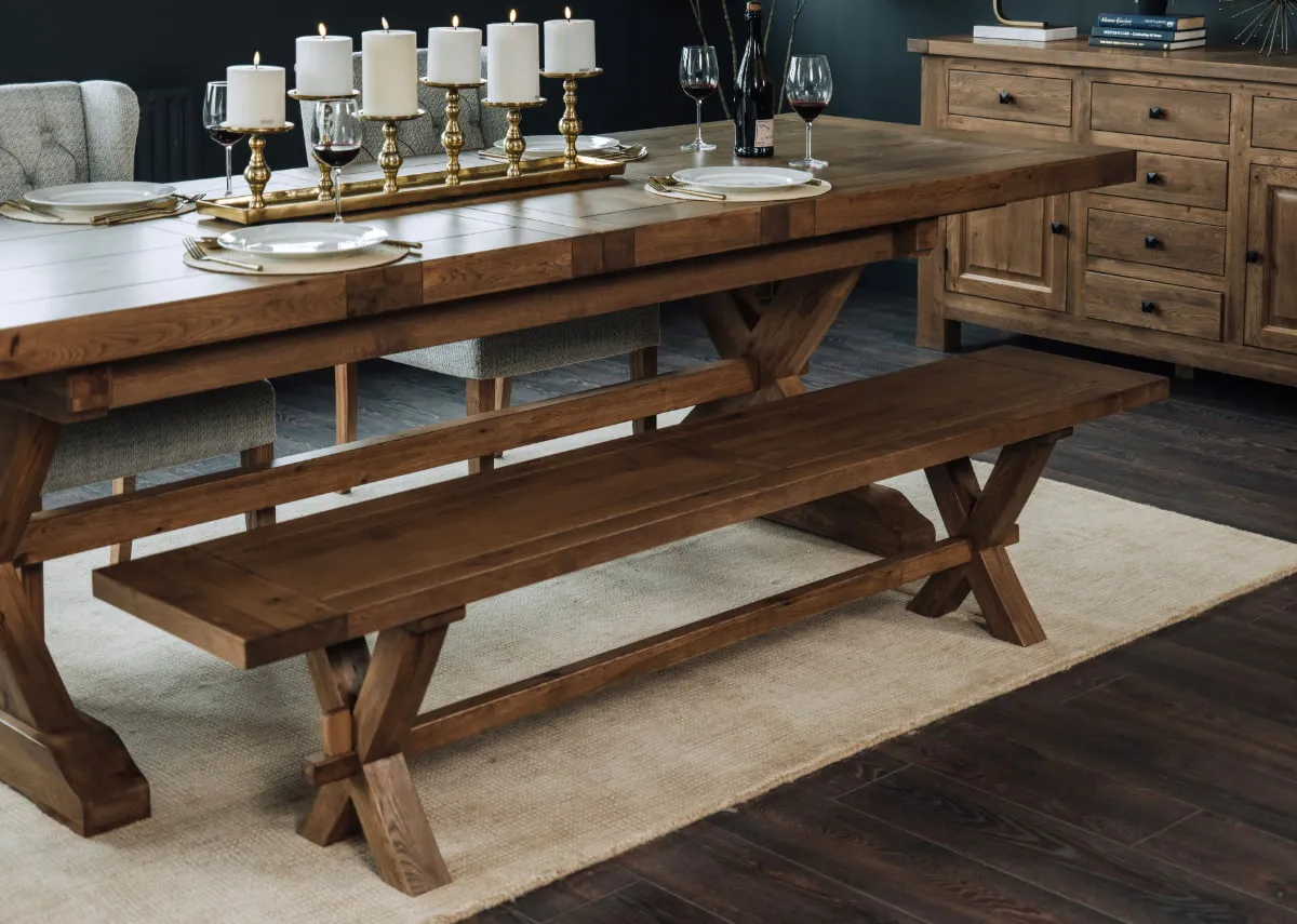 A lifestyle image of the Naxos bench with dining table and Charleston rug.