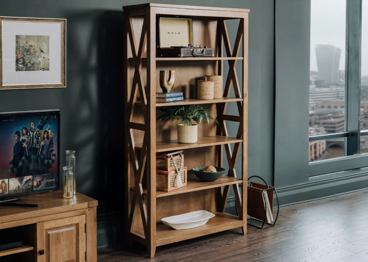 A lifestyle image of the Naxos bookcase with a selection of accessories including the ava baskets