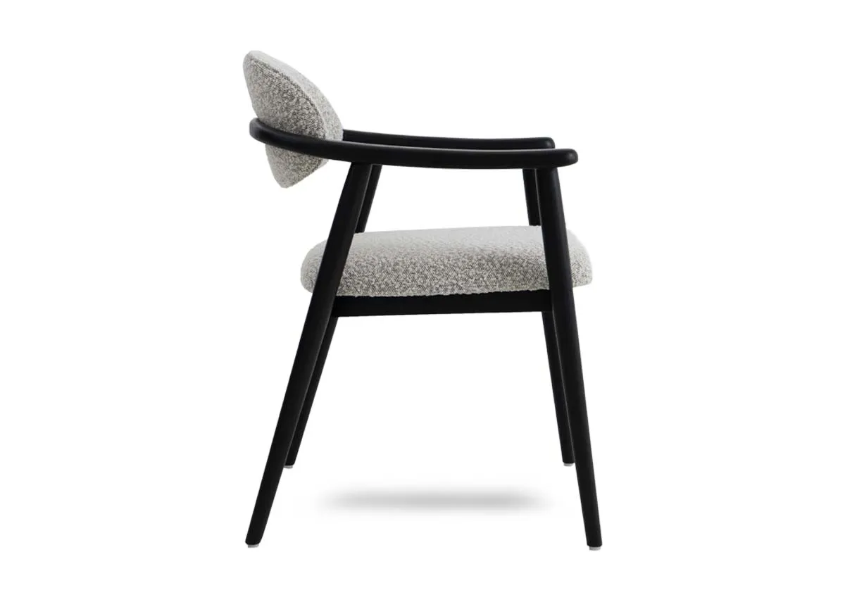 A black framed dining chair with grey boucle fabric from EZ Livings Rego range. Side view